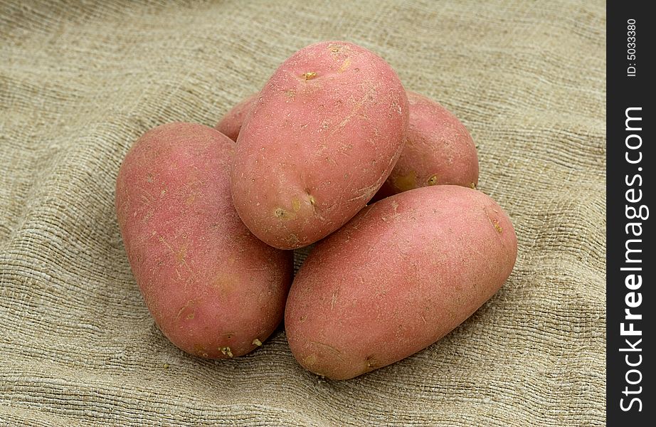 Five potatoes on a linen sack