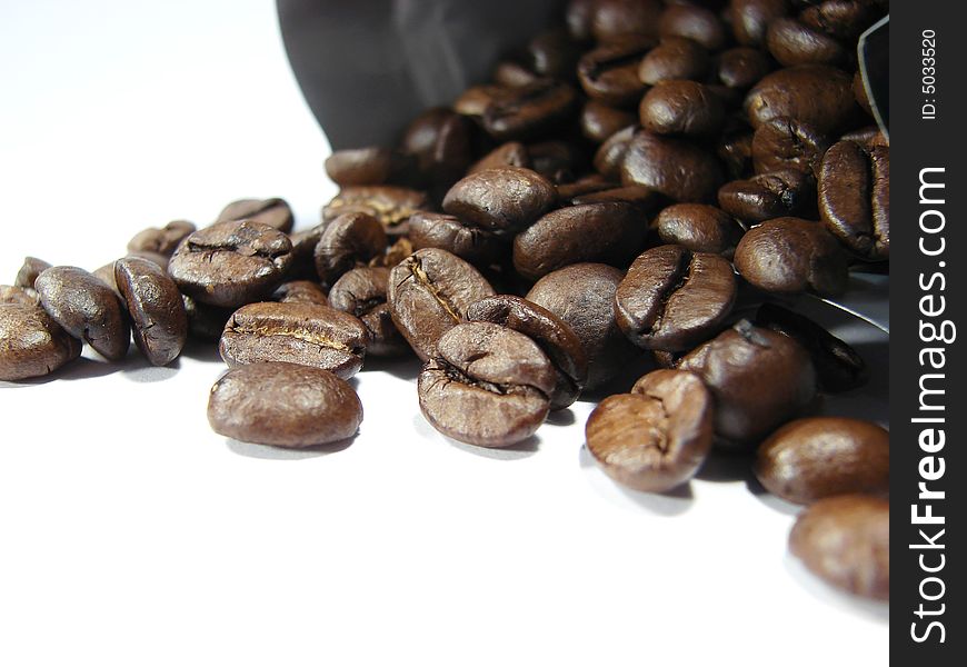 Natural coffee black brown beans closeup. Natural coffee black brown beans closeup
