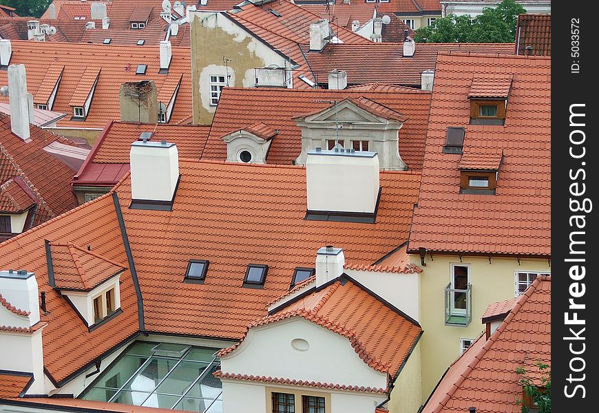 Wiev from above on red Prague roofs with white chimneys. Wiev from above on red Prague roofs with white chimneys