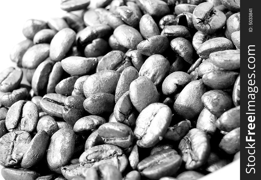 Natural coffee black brown beans closeup. Natural coffee black brown beans closeup