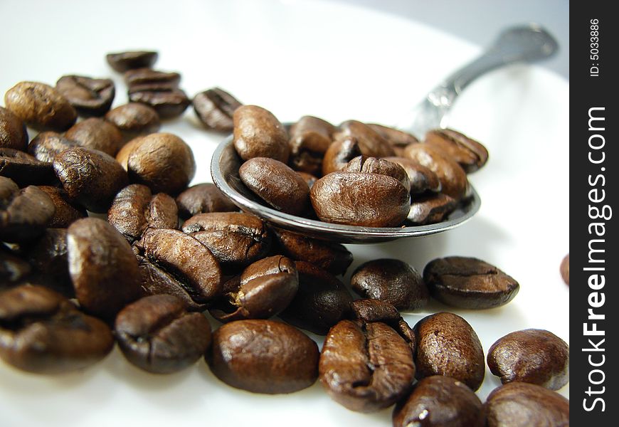 Natural coffee beans with spoon