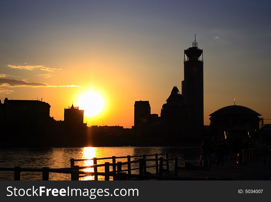 Sunset on the river with silhouettes