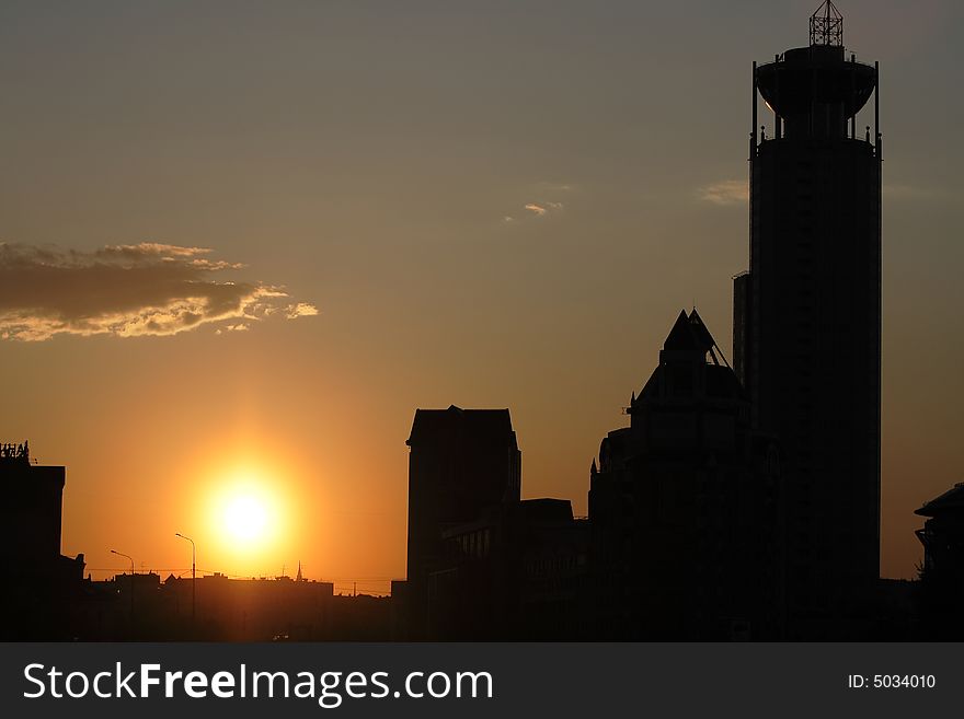 Sunset among the buildings in silhouettes. Sunset among the buildings in silhouettes