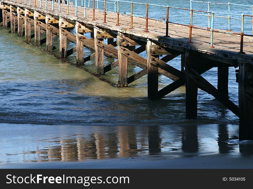 Old rusted ocean Pier at almost low tide