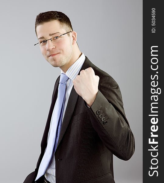 Portrait of young man in business clothes expressing satisfaction. Portrait of young man in business clothes expressing satisfaction