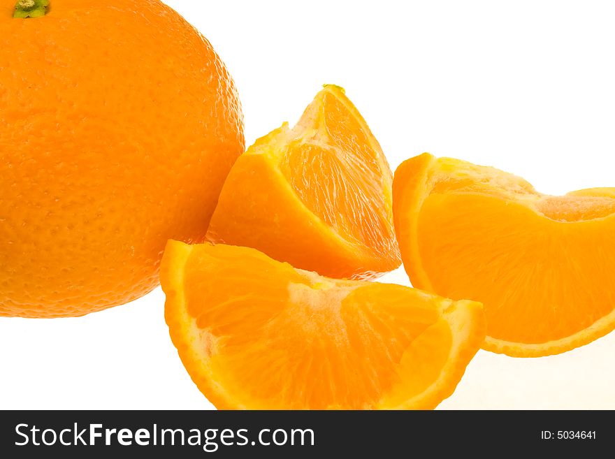 Whole orange plus segments against white background