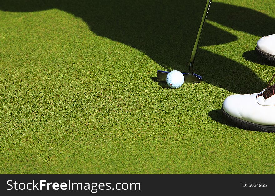 Top view of golfer in the green ready to strike the golf ball