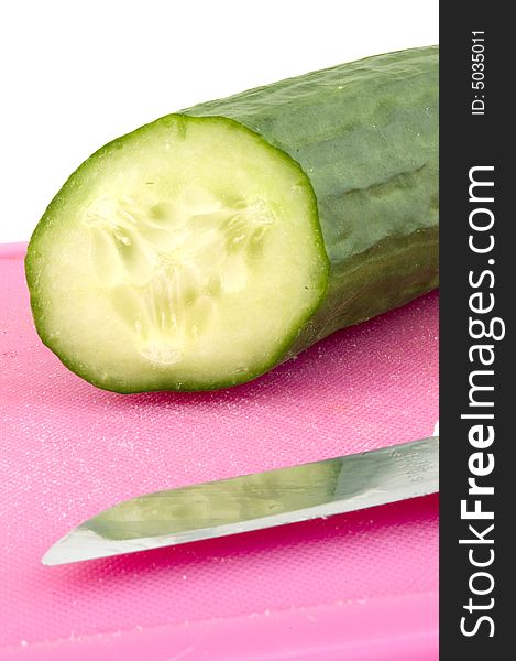 Part of a cucumber on a cutting board