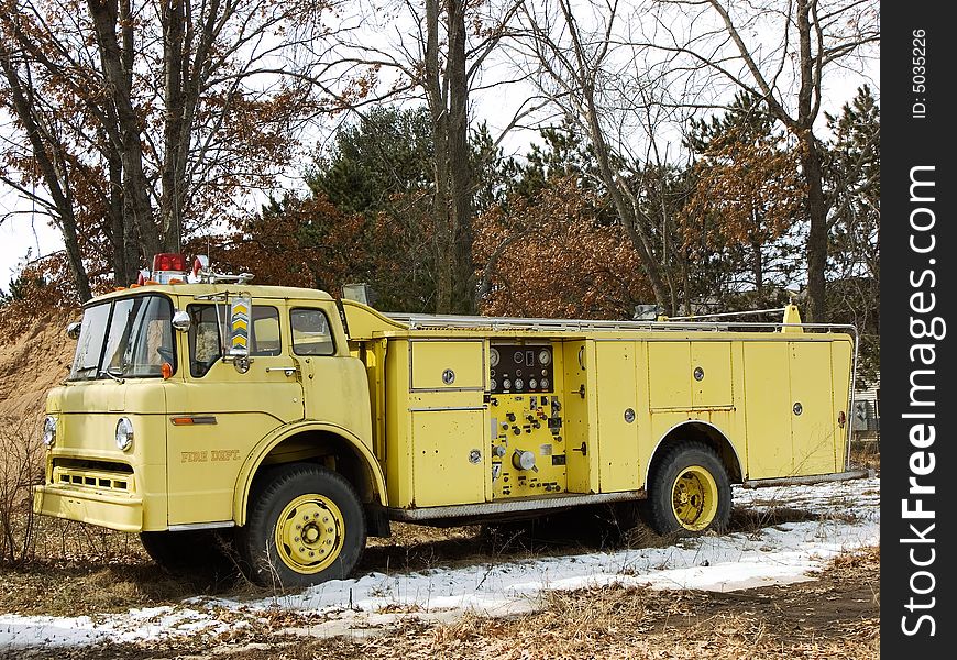 Old abandoned yellow firetruck not in use. Old abandoned yellow firetruck not in use