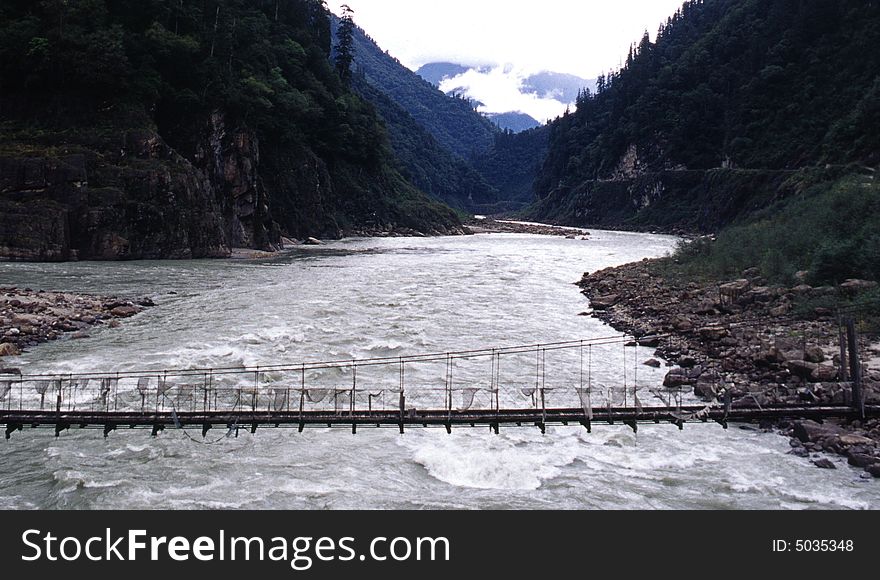 It is a river in the mountains, with a bridge. location is in Tibet of China.