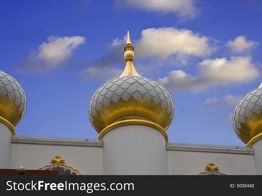 Taj Mahal Dome with white and gold on a deep blue sky with clouds. Taj Mahal Dome with white and gold on a deep blue sky with clouds