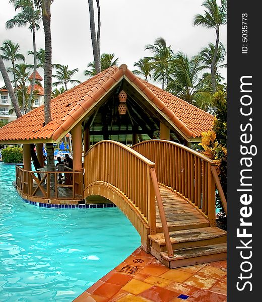 Small hut that is in the middle of a large swimming pool on a nice tropical resort. Small hut that is in the middle of a large swimming pool on a nice tropical resort.