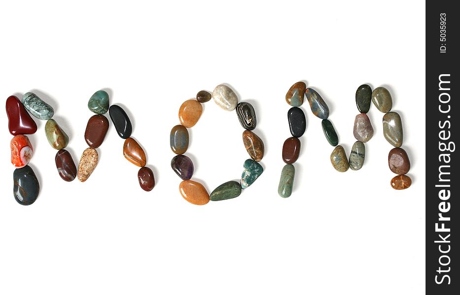 The word MOM spelled out in polished stones and gems. The word MOM spelled out in polished stones and gems