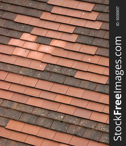 Roof made up of different colored roof tiles. Roof made up of different colored roof tiles