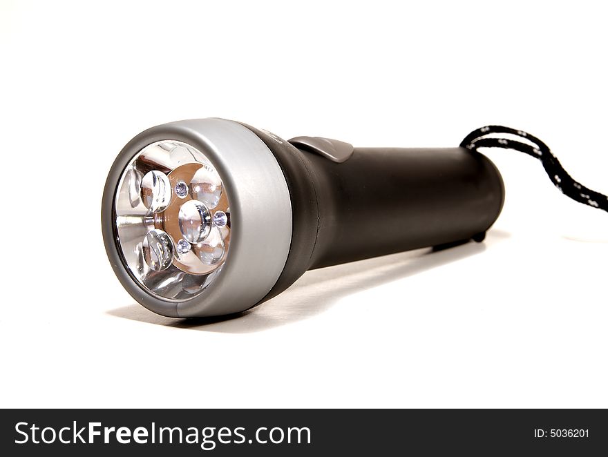 A black flashlight torch on a white seemless background. A black flashlight torch on a white seemless background.