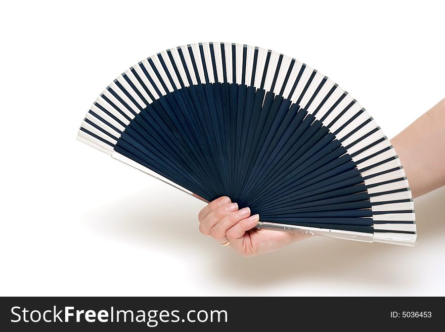 The hand holds a fan on a white background. The hand holds a fan on a white background