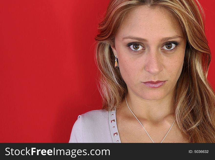 Attractive woman look to the camera on the red background. Attractive woman look to the camera on the red background