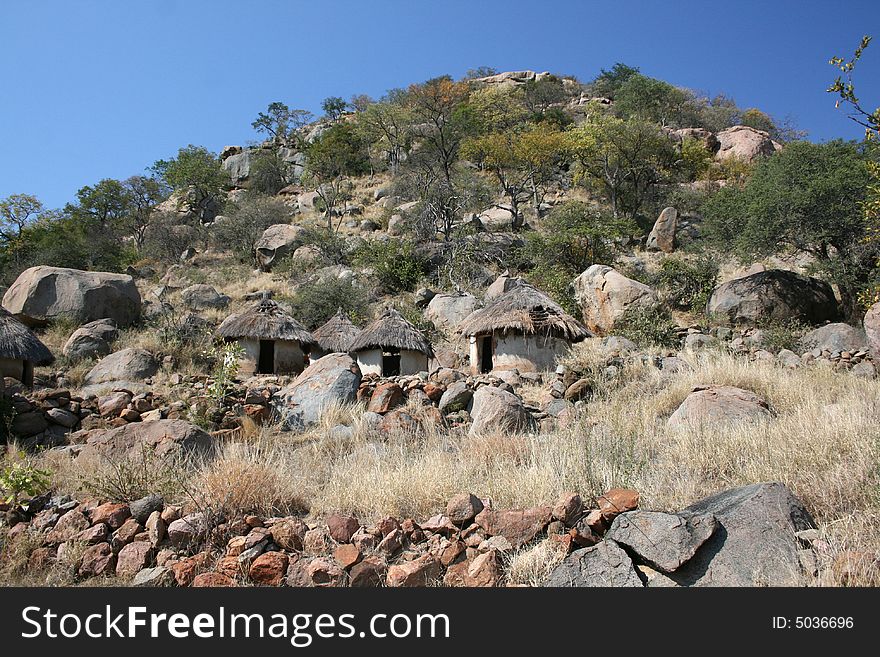 African Tribal Settlement at the foot of a granite hill.