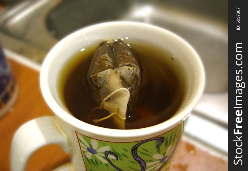 Close up for a tea bag inside a cup