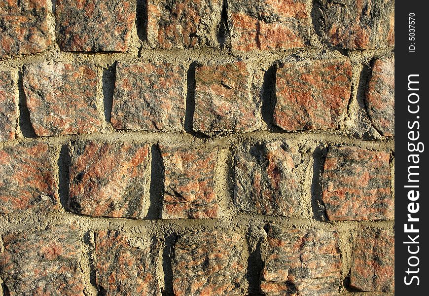 Rough red granite wall texture. Rough red granite wall texture