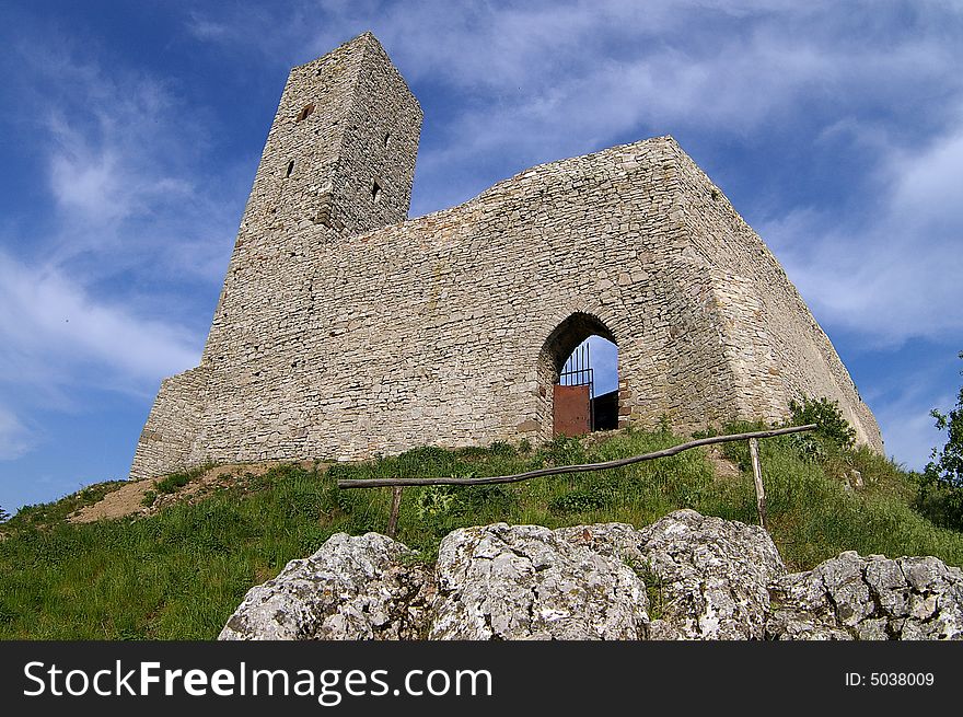 Historical castle in mountains with blue sky