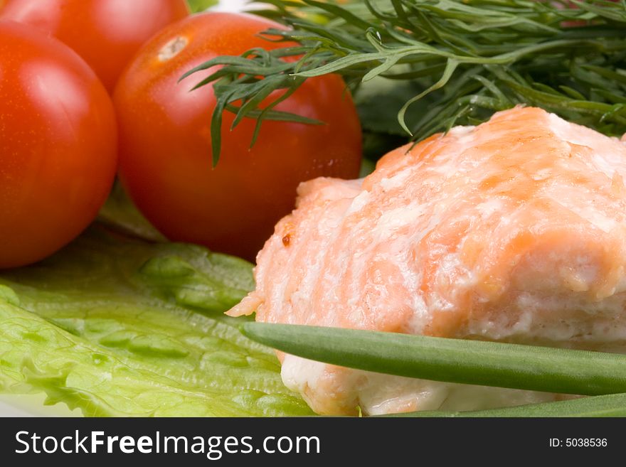 Stake from a salmon with vegetables on a plate