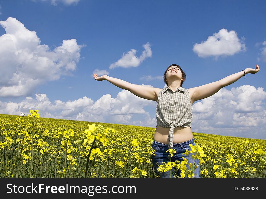 Young attractive woman having fun in rape field. Young attractive woman having fun in rape field