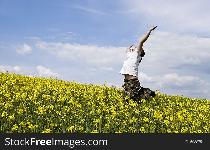 Young attractive man jumping in summer field. Young attractive man jumping in summer field