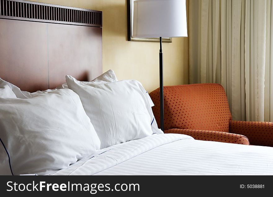 Comfortable bed with fresh white linens in hotel room. Comfortable bed with fresh white linens in hotel room