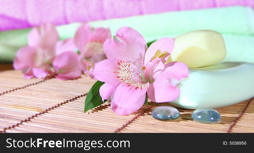 Soap, towels and pink flowers