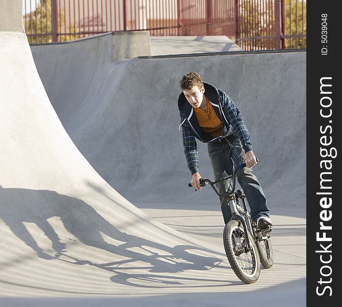 Kid bikes through skate park. Kid bikes through skate park