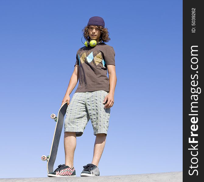 Teen skater atop ramp