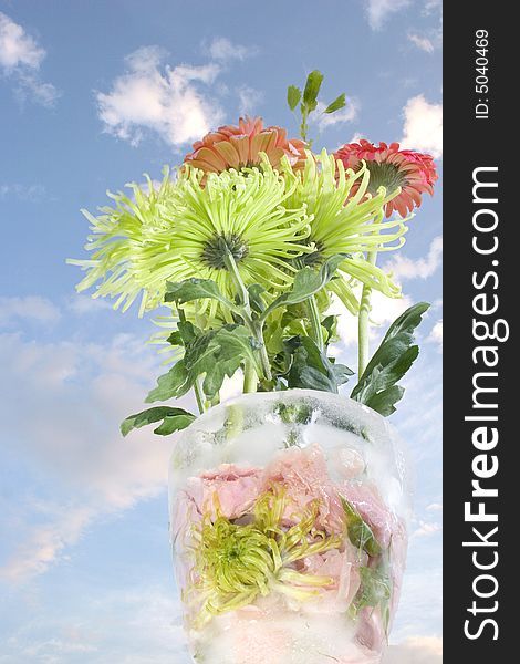 A bouquet of flowers in a vase made of ice and frozen flowers. A bouquet of flowers in a vase made of ice and frozen flowers.