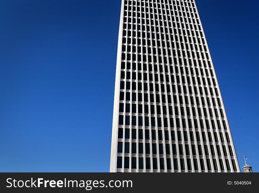 White modern skyscraper located in downtown. White modern skyscraper located in downtown