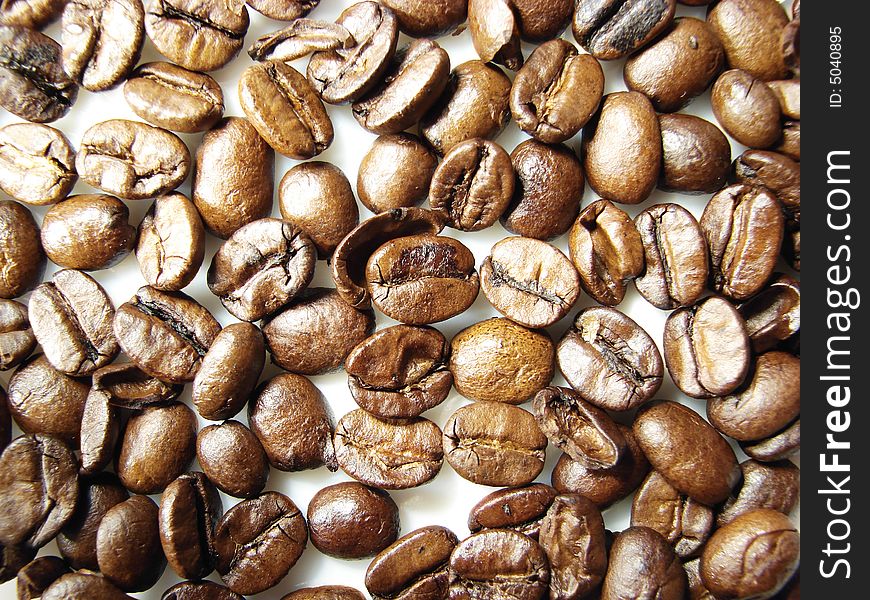 Natural coffee black brown beans closeup. Natural coffee black brown beans closeup