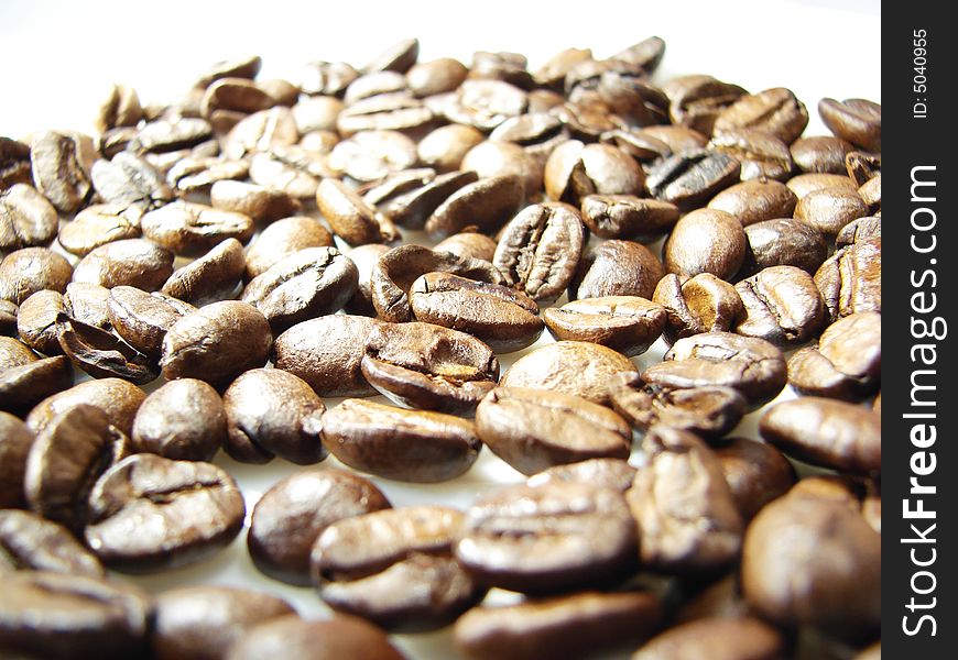 Natural coffee black brown beans closeup. Natural coffee black brown beans closeup