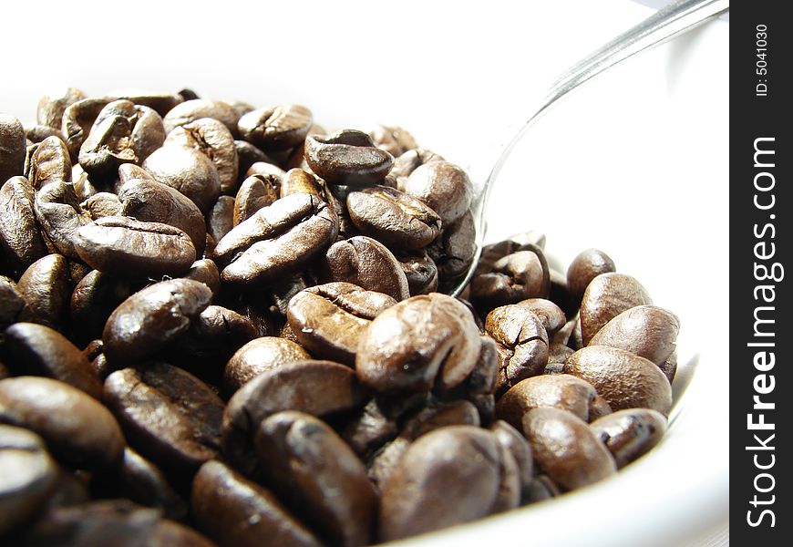 Natural coffee beans with spoon