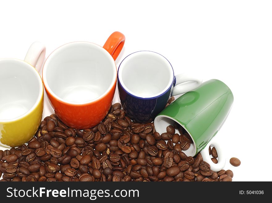 Cups with roasted coffee beans
