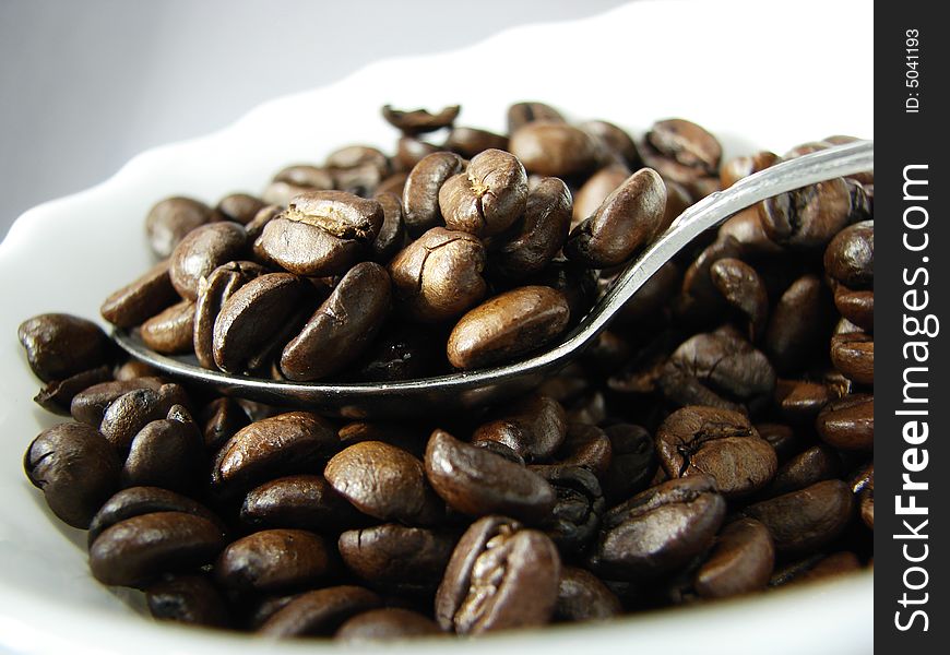 Natural coffee beans and spoon