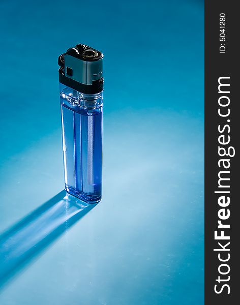 The inexpensive cigarette lighter on blue