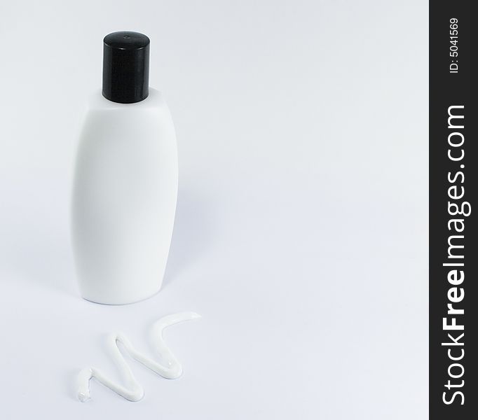 Cream and white bottle with black cap