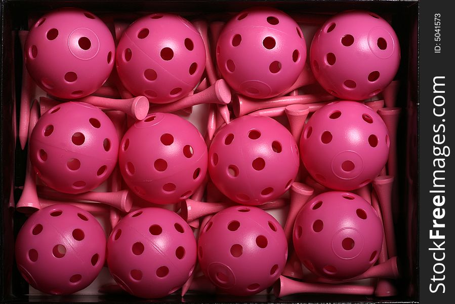 Box of Pink Golf Practice Balls and Tees. Box of Pink Golf Practice Balls and Tees