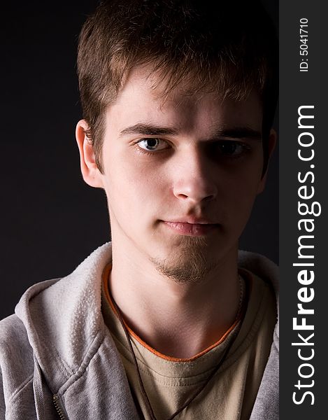 The young guy in studio on a black background