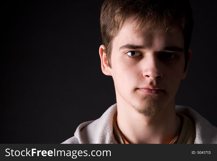The young guy in studio on a black background