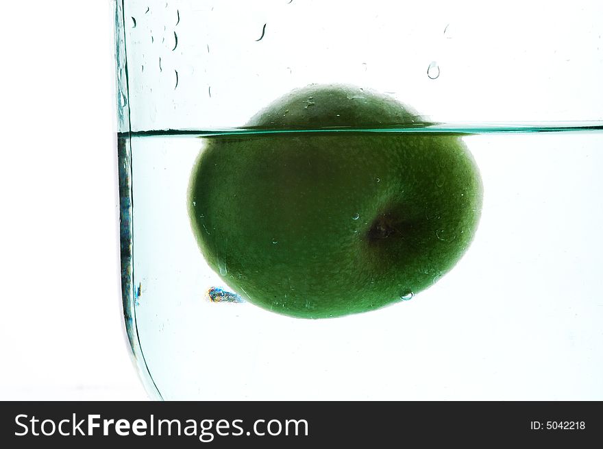 Green apple in whater. Isolated