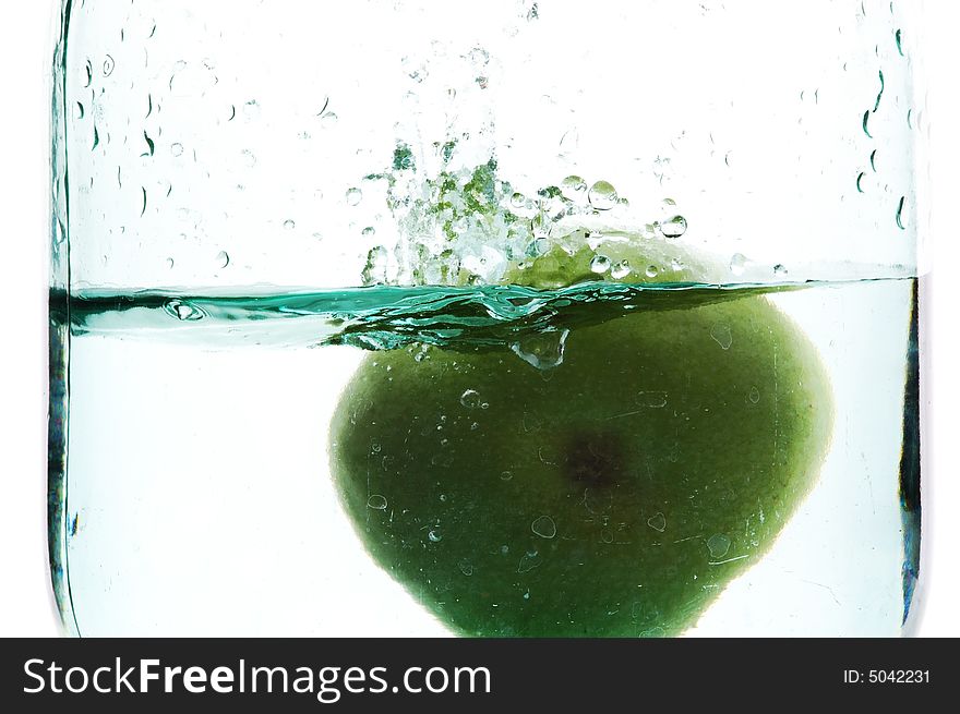 Splashing green apple on botlle