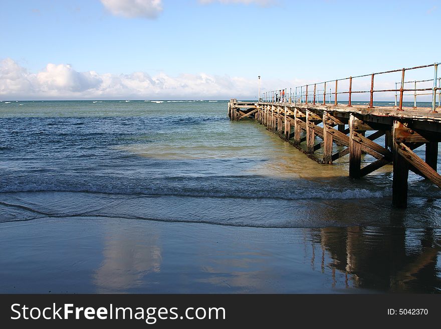 Old rusted ocean Pier at almost low tide