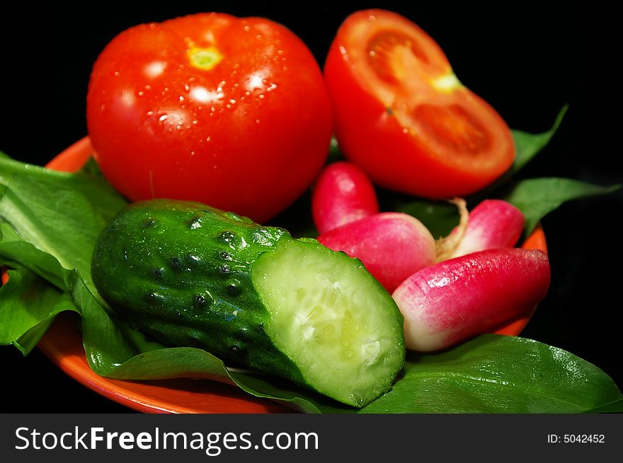 Spring salad from cucumbers, tomatoes and a garden radish. Spring salad from cucumbers, tomatoes and a garden radish