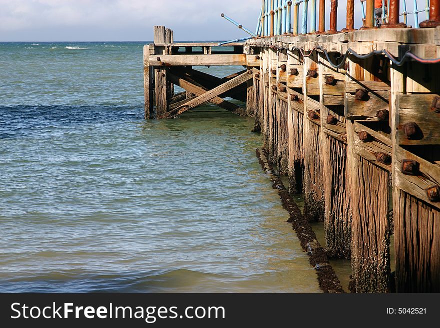 Old rusted ocean Pier at almost low tide