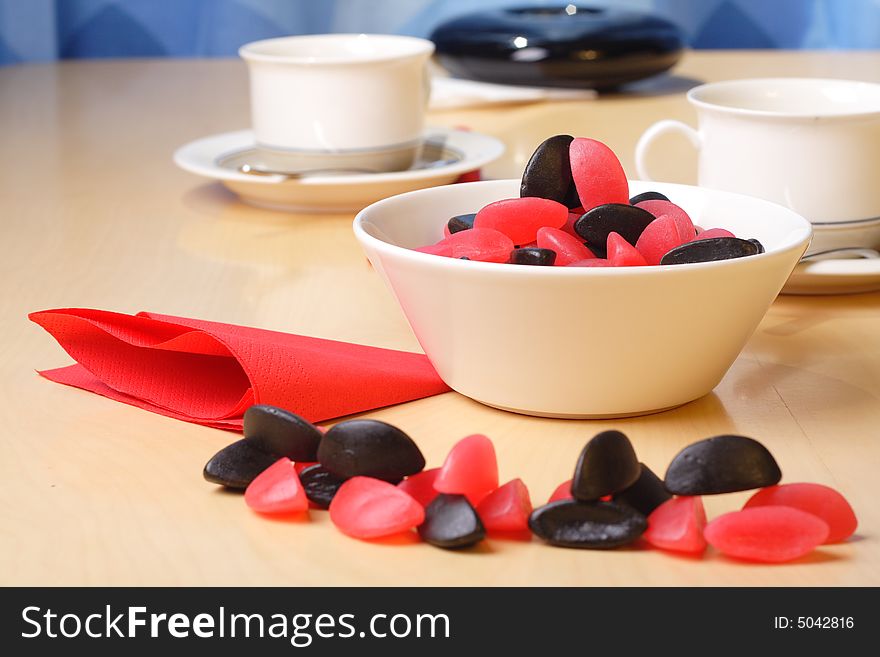 Candy with coffee cups in the background. Candy with coffee cups in the background